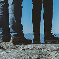 A man and a woman standing at the top of a rock overlooking the view in Tennessee